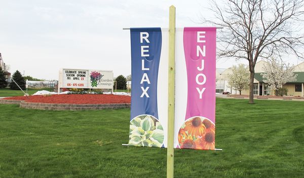 Large, easy-to-read roadside banners for Garden Crossings in Zeeland, MI get drivers' attention. There are four banners and each one has a different plant picture to show a variety of plants offered.
